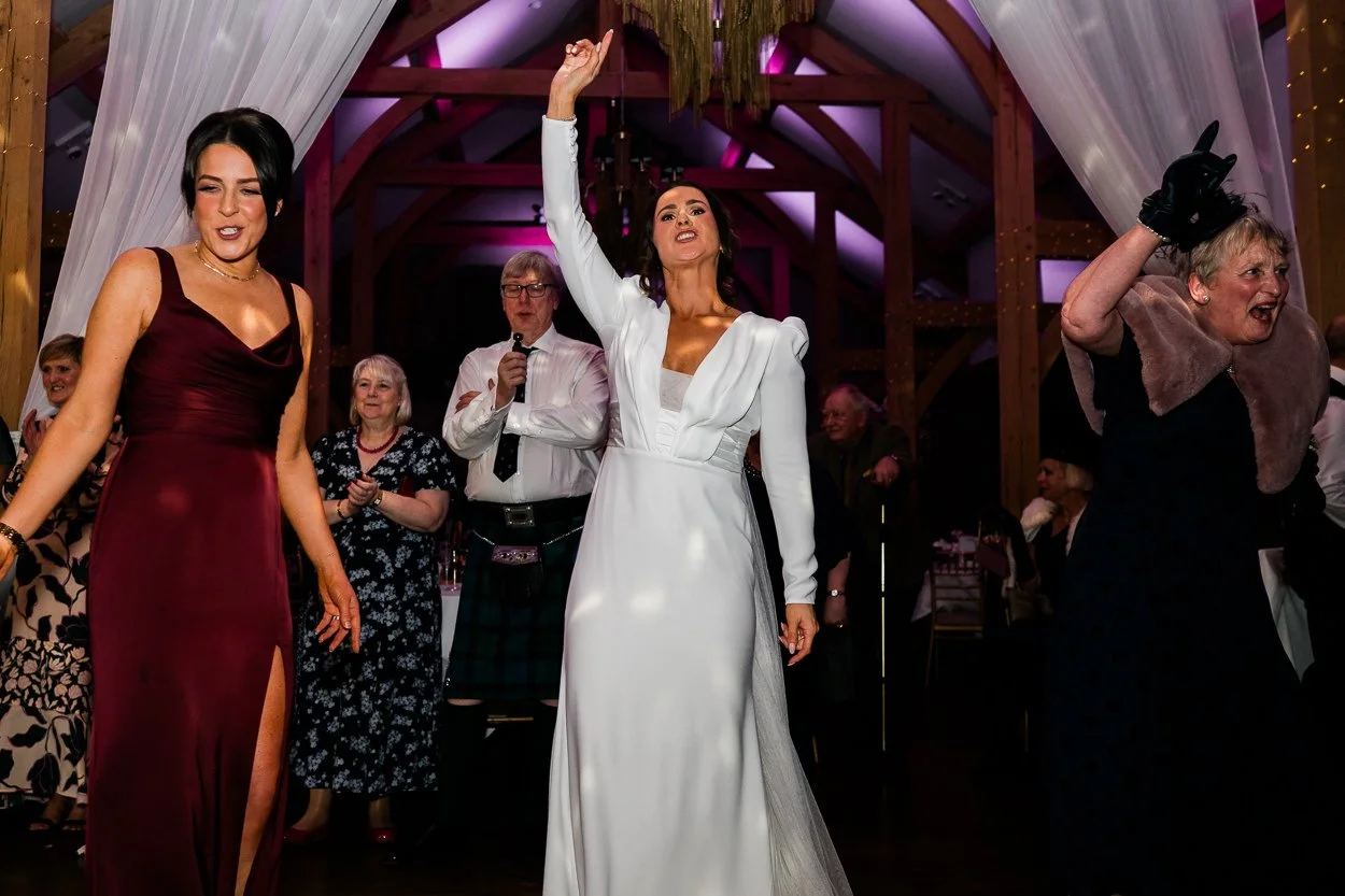 Bride pointing to the sky and dancing