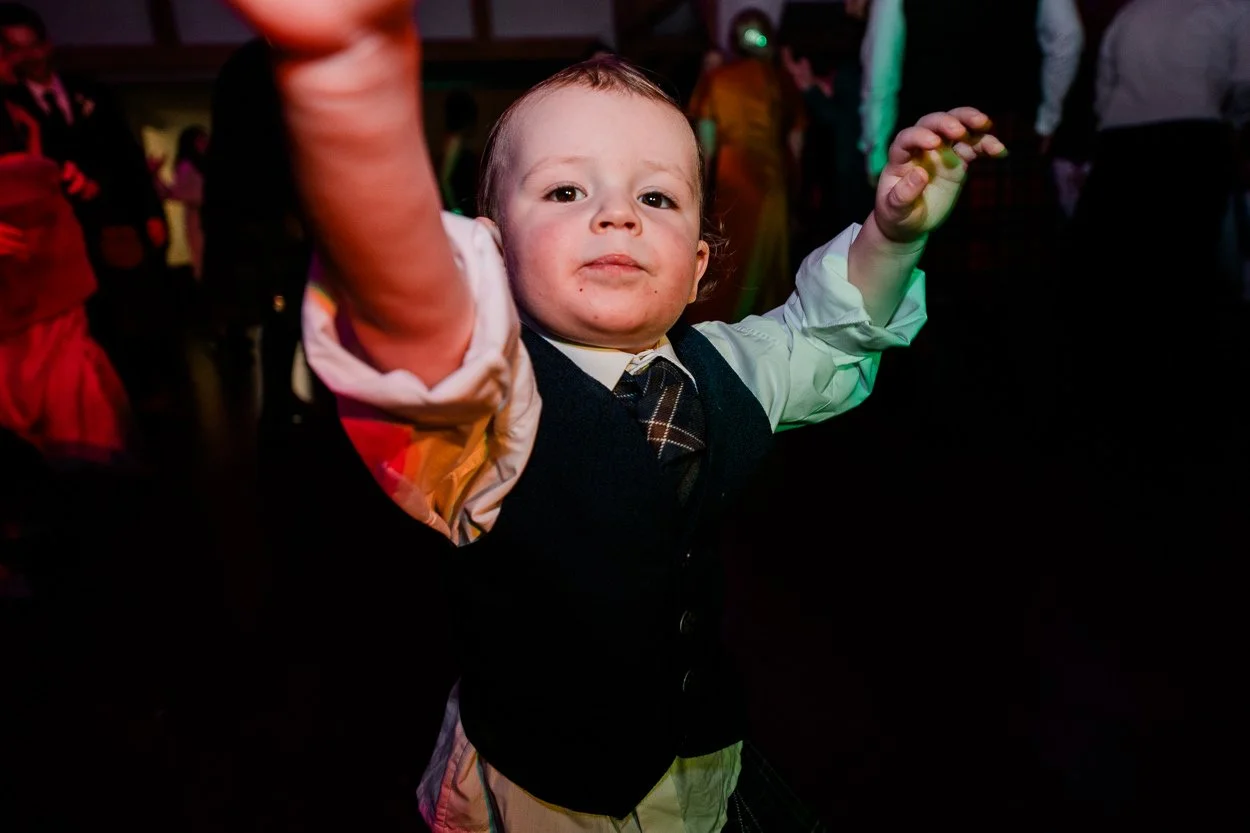 Little-boy-engaging-with-camera-on-wedding-dance-floor