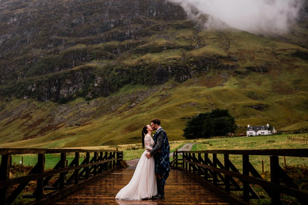 Glencoe wedding portrait on a bridge in the rain