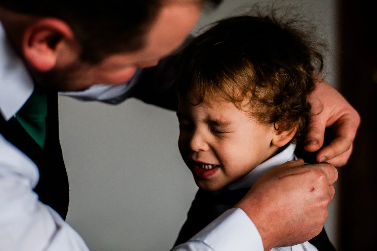 Groom-fixing-reluctant-page-boys-collar