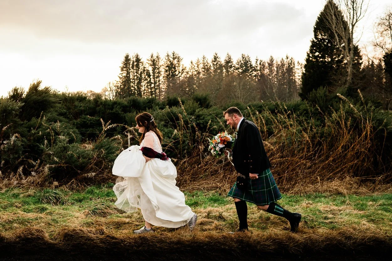 Bride and groom walking through the wilds of Scotland