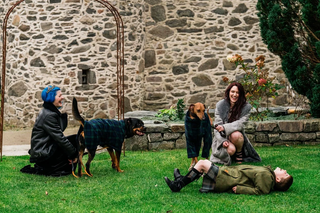 Two-brides-son-and-dog-falling-over-and-laughing-kilmartin-castle-wedding