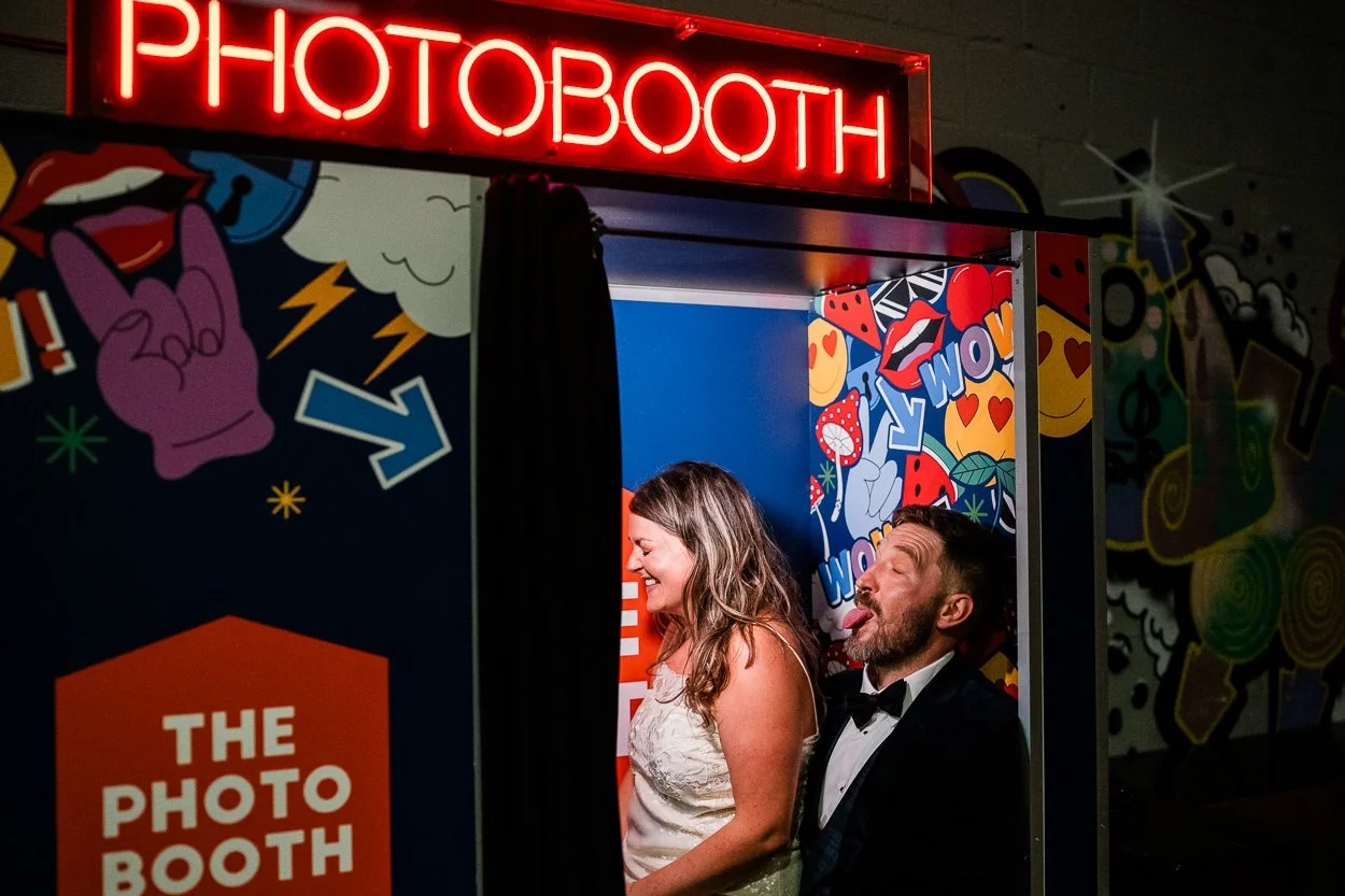 Bride-and-groom-pulling-solly-faces-in-photobooth