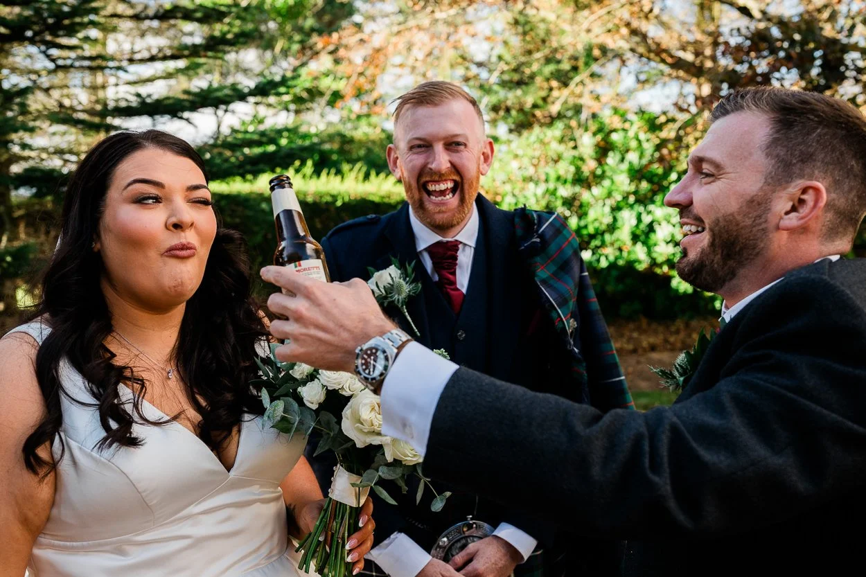 Bride-being-fed-beer-at-wedding