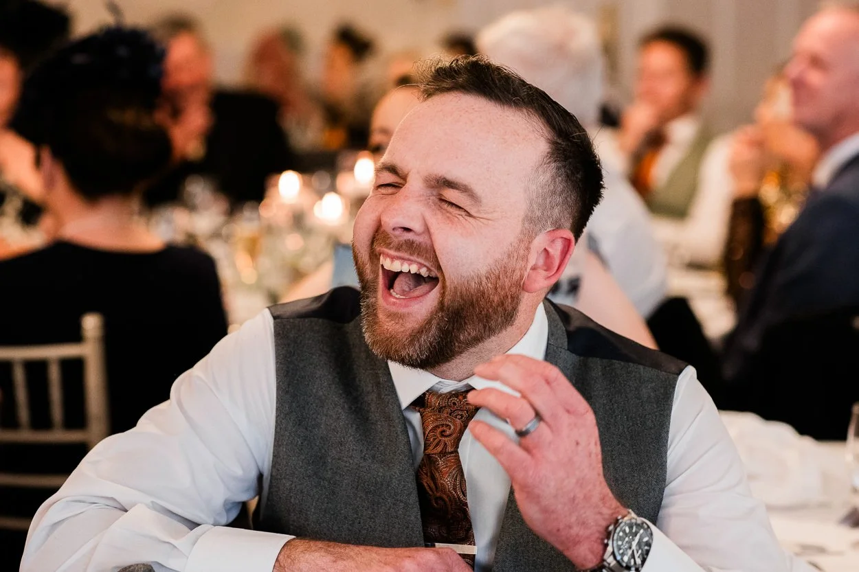 Wedding guest laughing during speeches