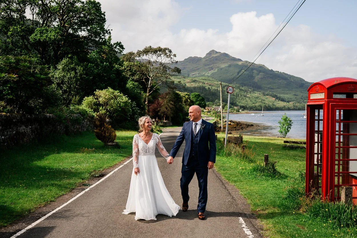 Bride and groom portrait with red phone box
