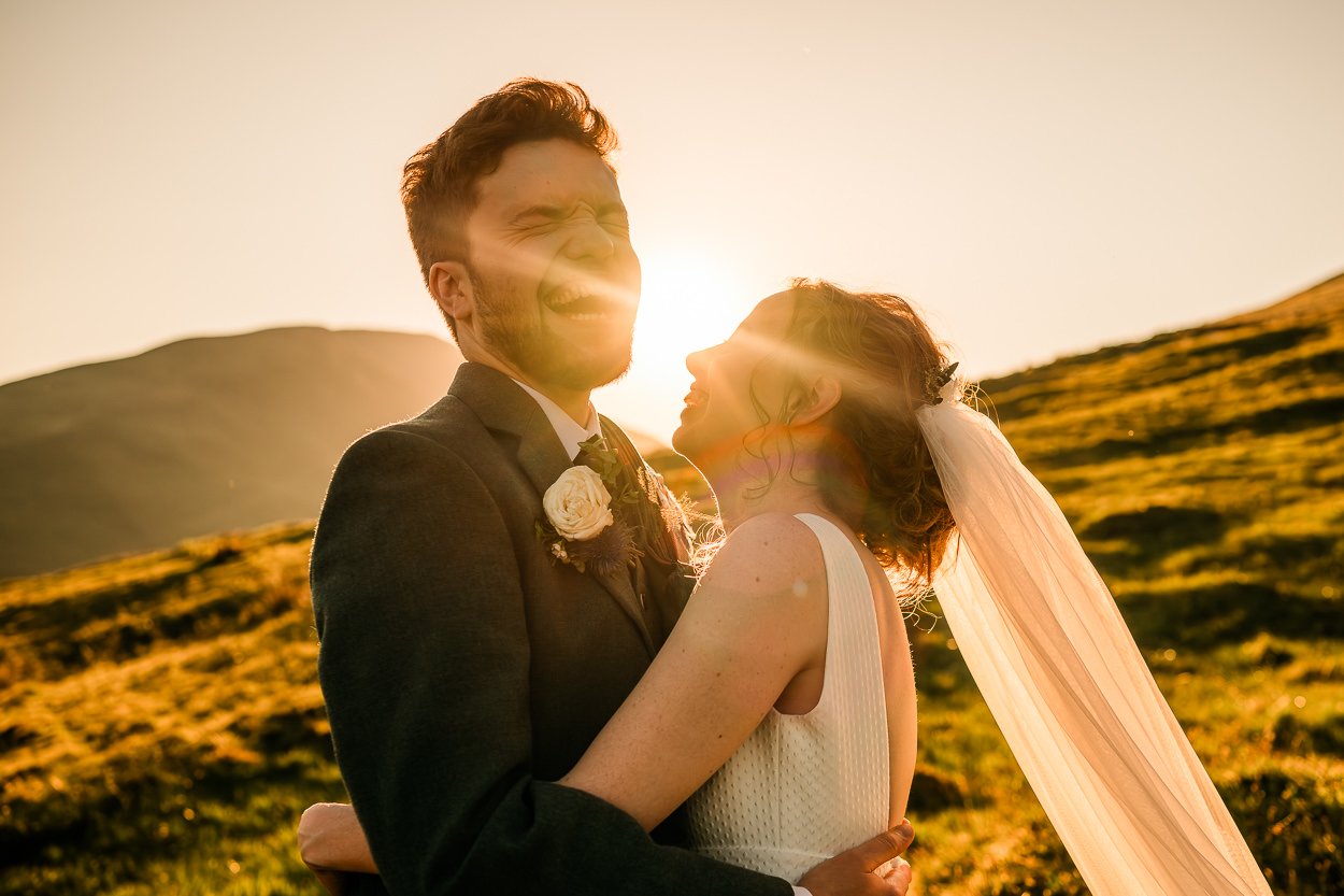 Sunset-laughter-bride-and-groom-up-Scottish-hill