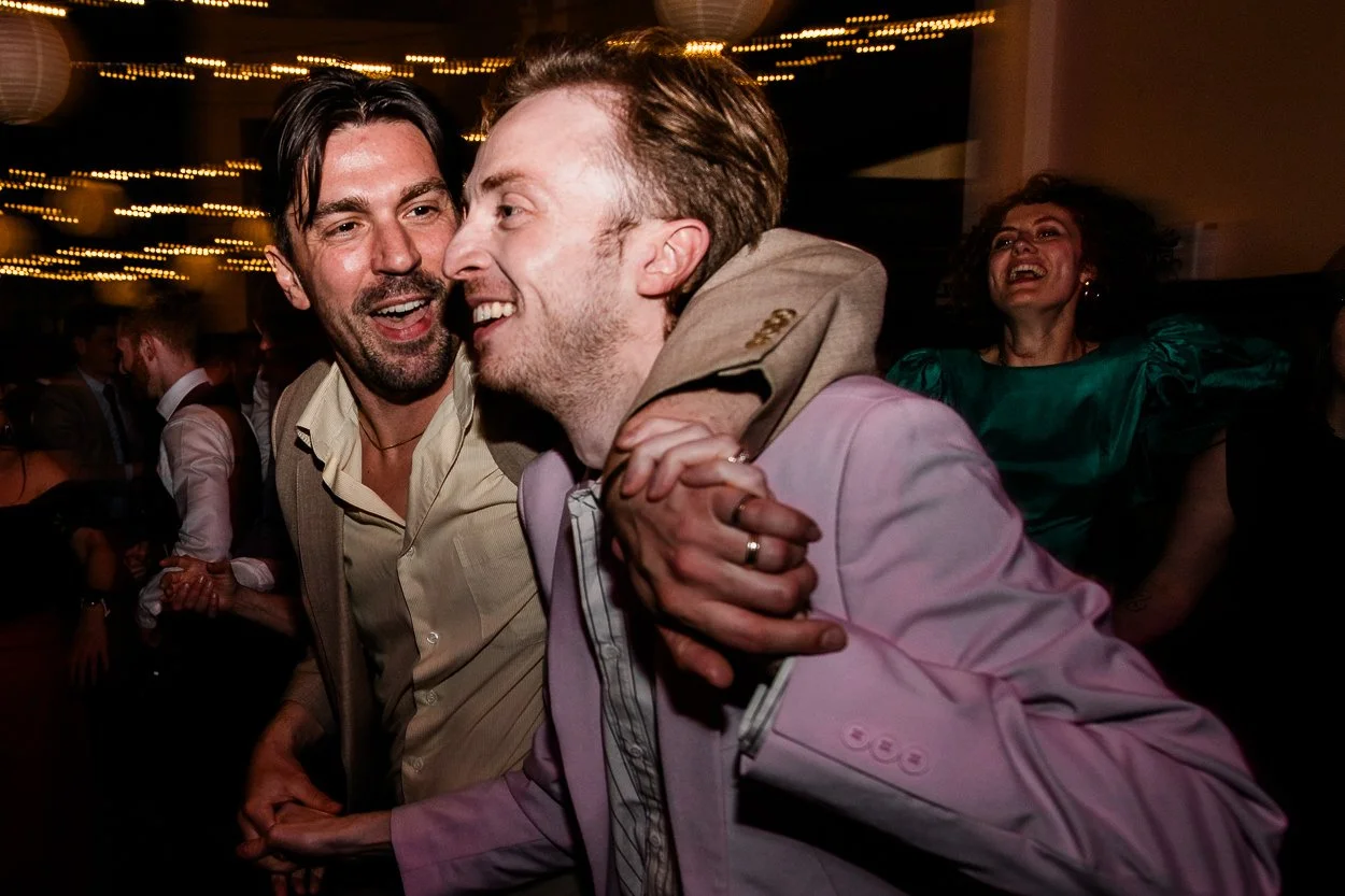 High-energy-dancing-between-two-men-at-wedding