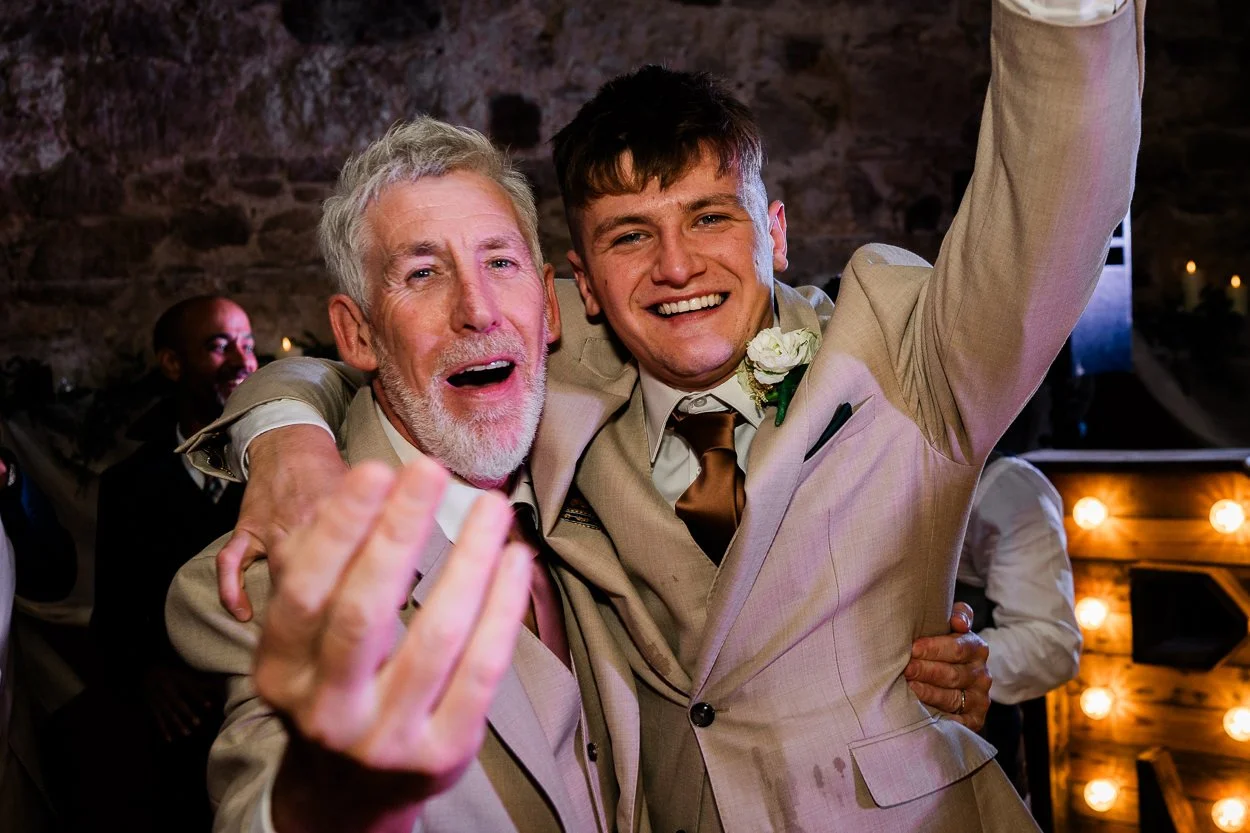 Two-men-dancing-energetically-at-Rosebery-Steading-wedding
