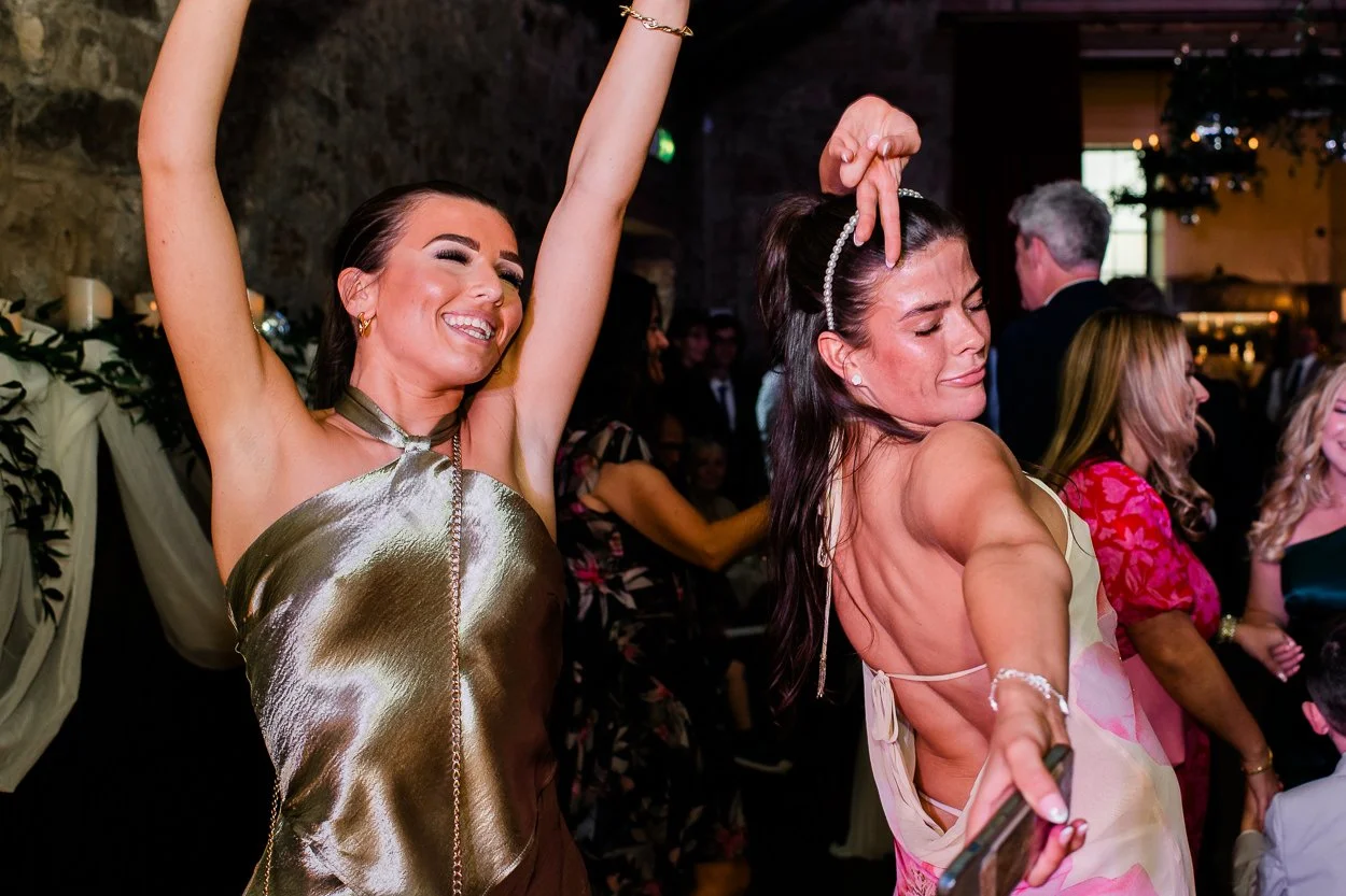 Two guests dancing at a high energy wedding
