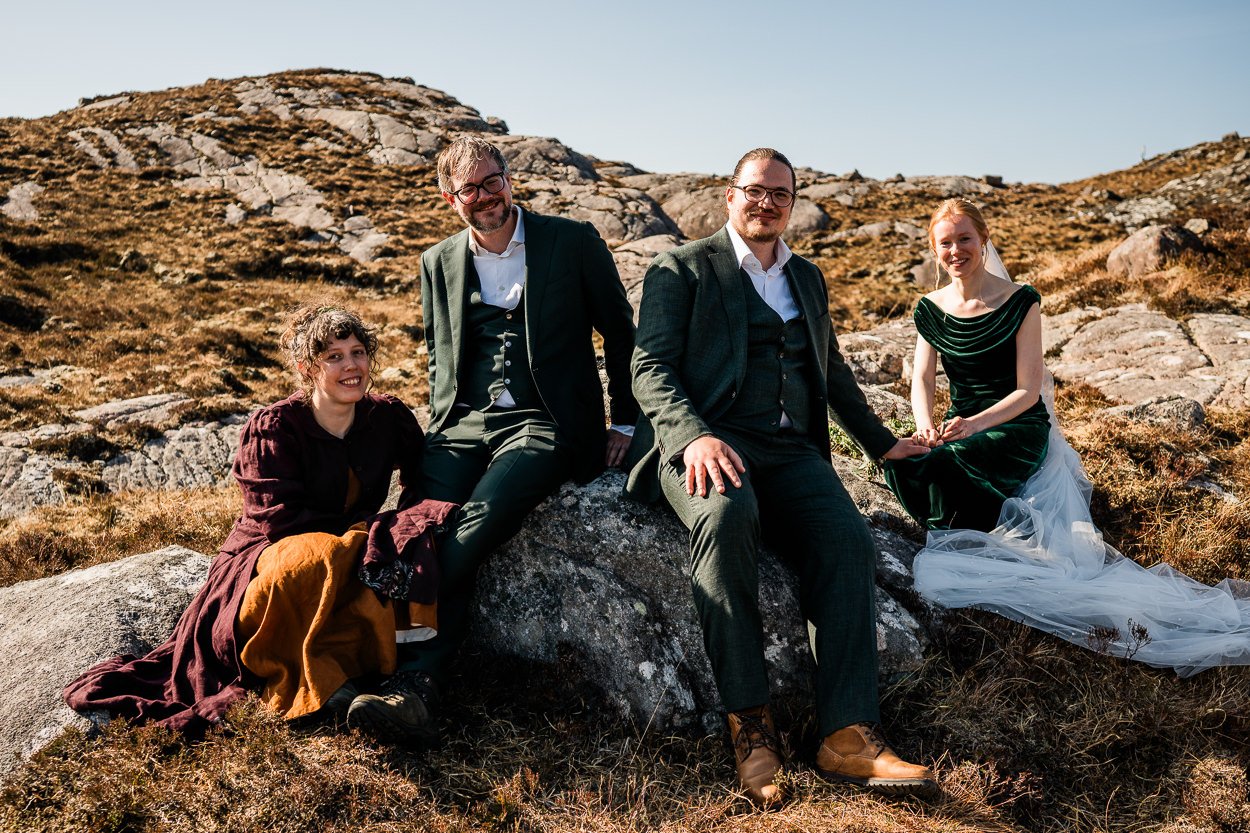 Bride and groom sitting with friend on top of a Torridon mountain 