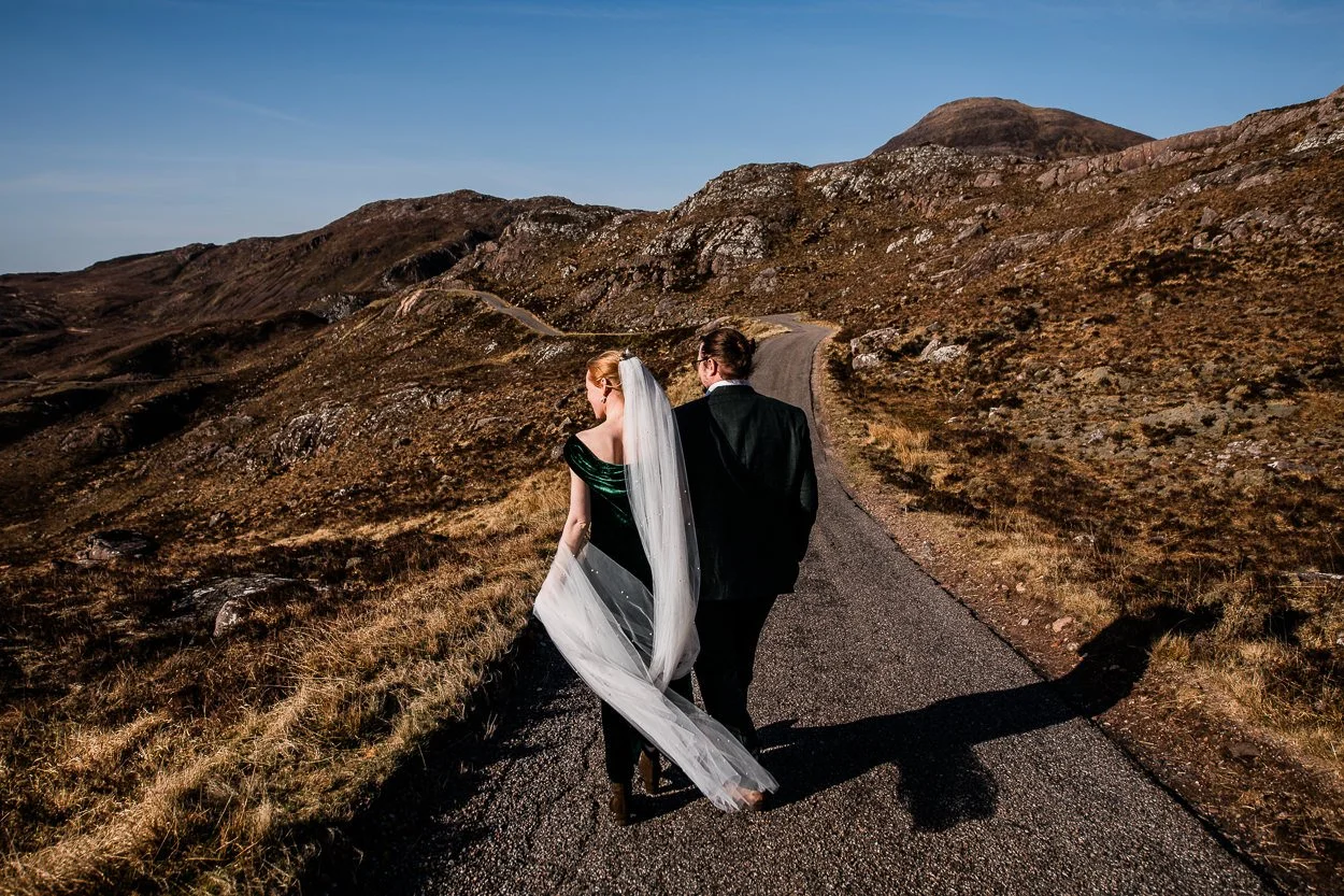 Bride-and-groom-walking-down-remote-Torridon-road