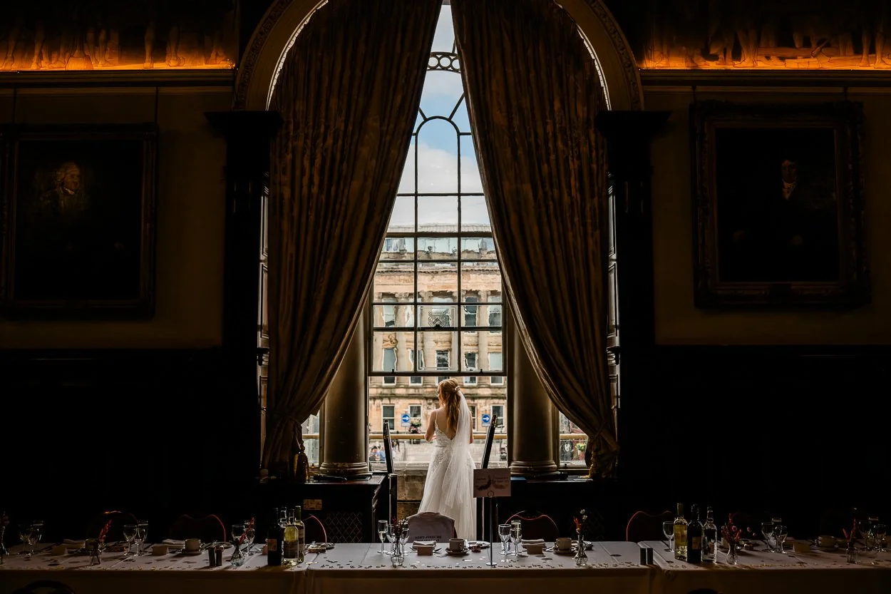 Bride-looking-over-balcony-from-behind