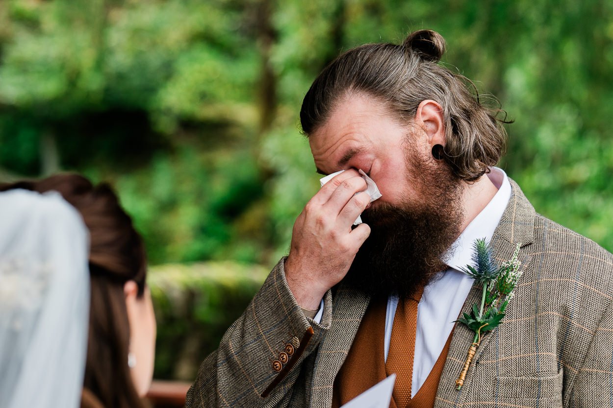 Groom crying during vows at wild elopement