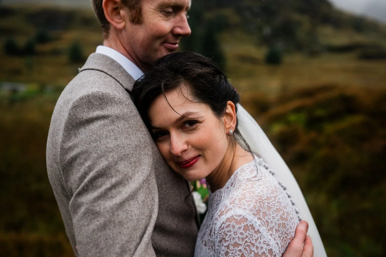 Bride and groom hugging on a mountain