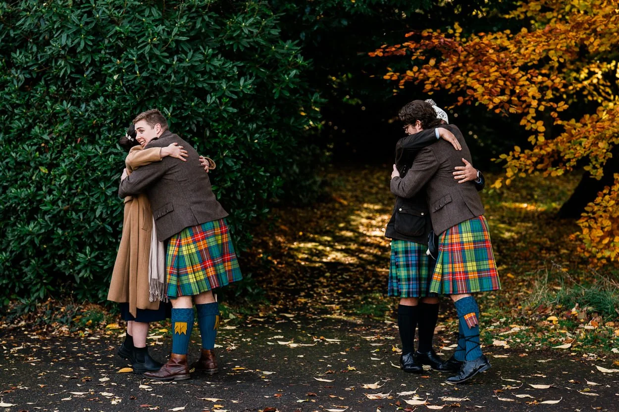 Groomsmen embracing guests at Byre at Inchyra