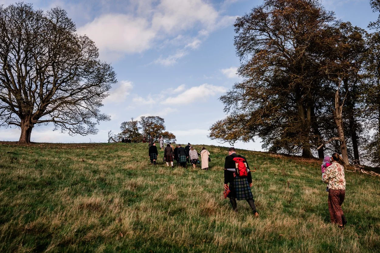 Guests walking up to hilltop ceremony at Byre at Inchyra