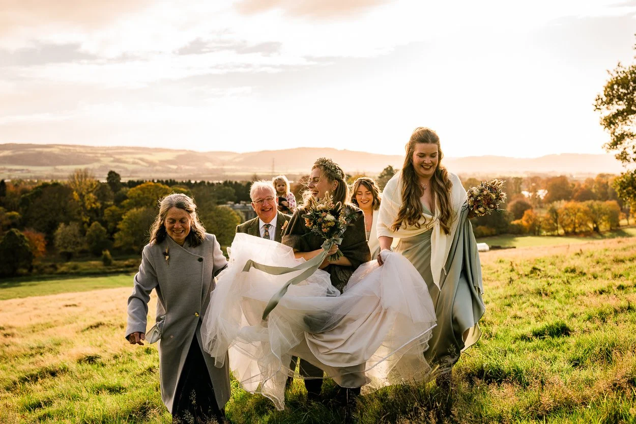 Bridal party hiking up to hilltop ceremony at Byre at Inchyra