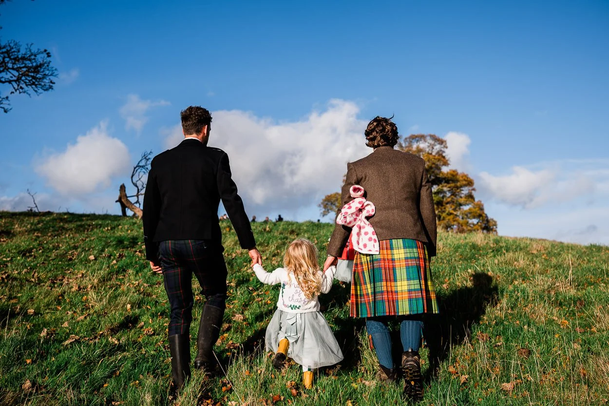 Flower girl and groomsmen hiking to hilltop ceremony
