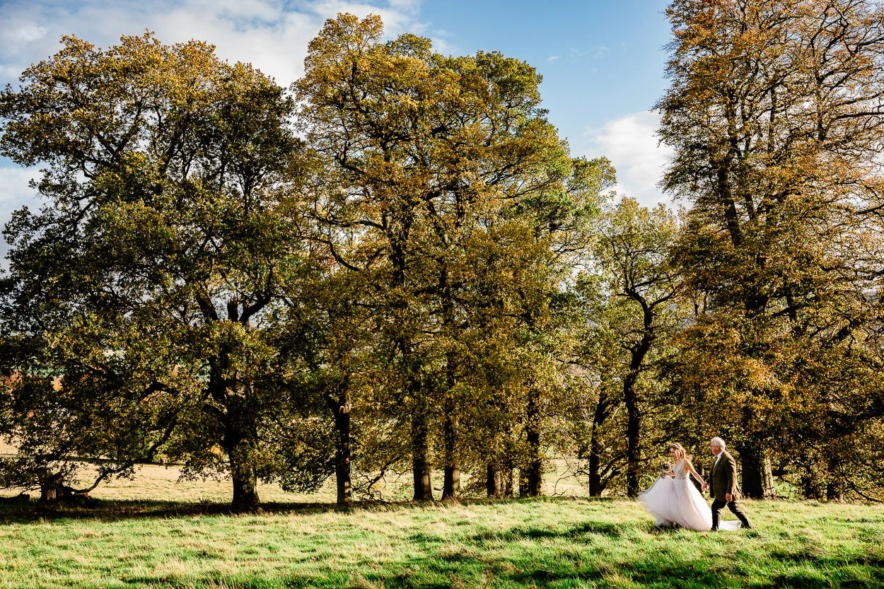 Bride and father arriving to hilltop ceremony Byre at Inchyra