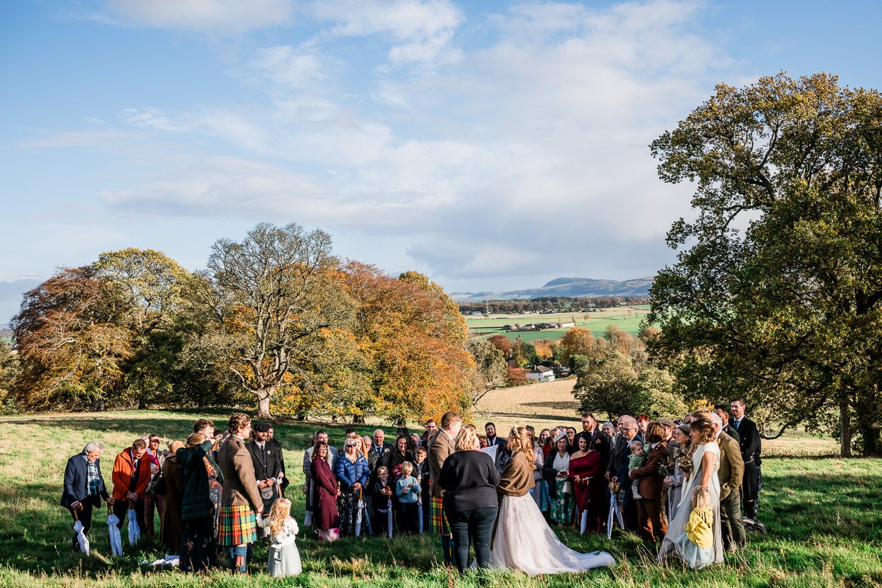 Wide shot of guests at hilltop ceremony at Byre at Inchyra