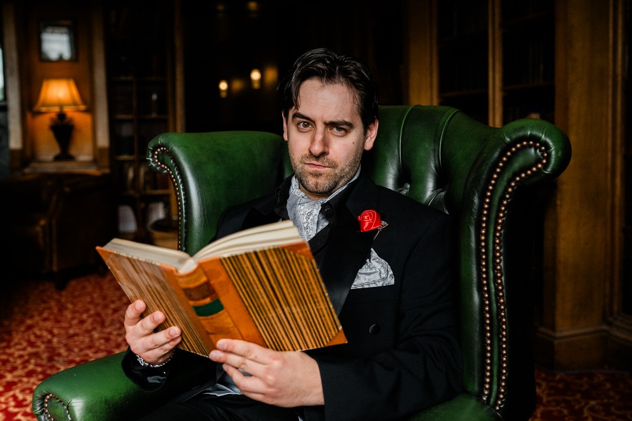 Groom reading a book in Dalhousie Castle library