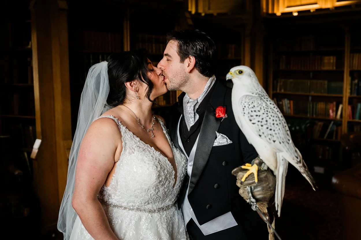 Bride and groom holding bird Dalhousie Castle