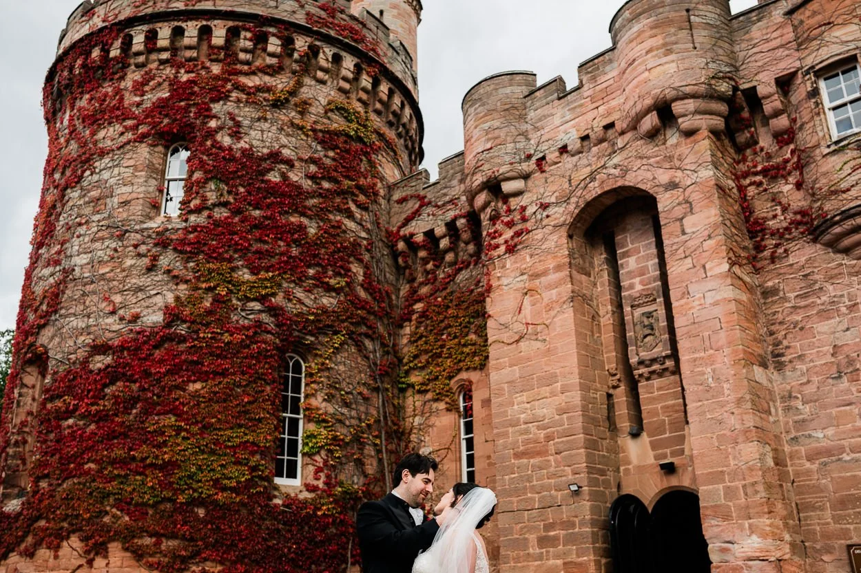 Bride and groom portrait in front of Dalhousie Castle