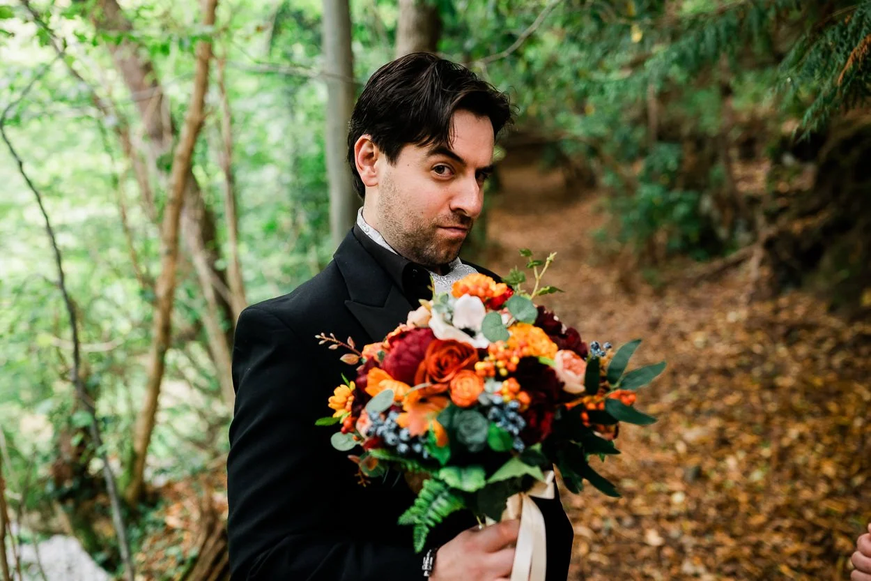 Groom holding flowers