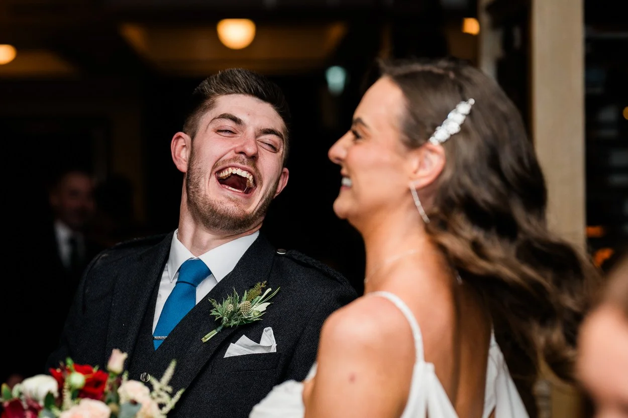 Candid photography of guest laughing