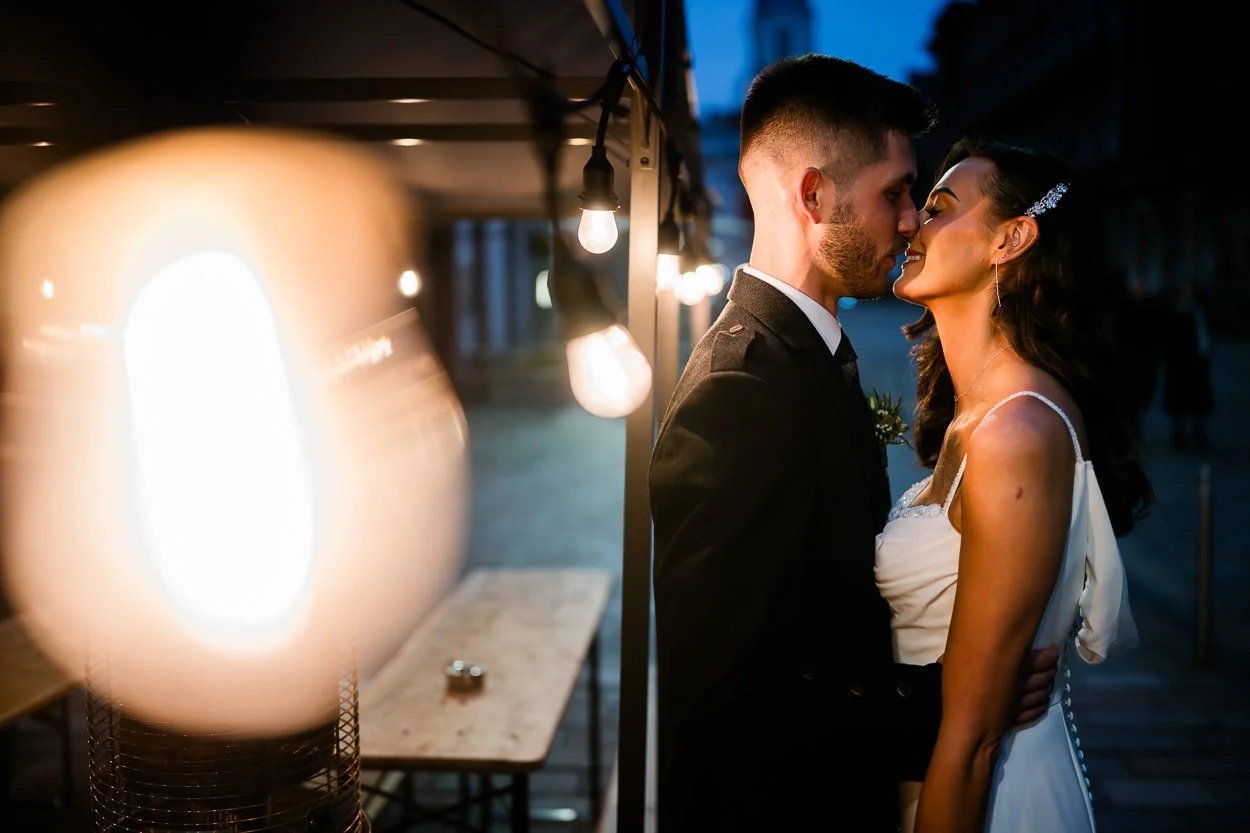 Emotional moment between bride and groom and the Glasgow city evening lights