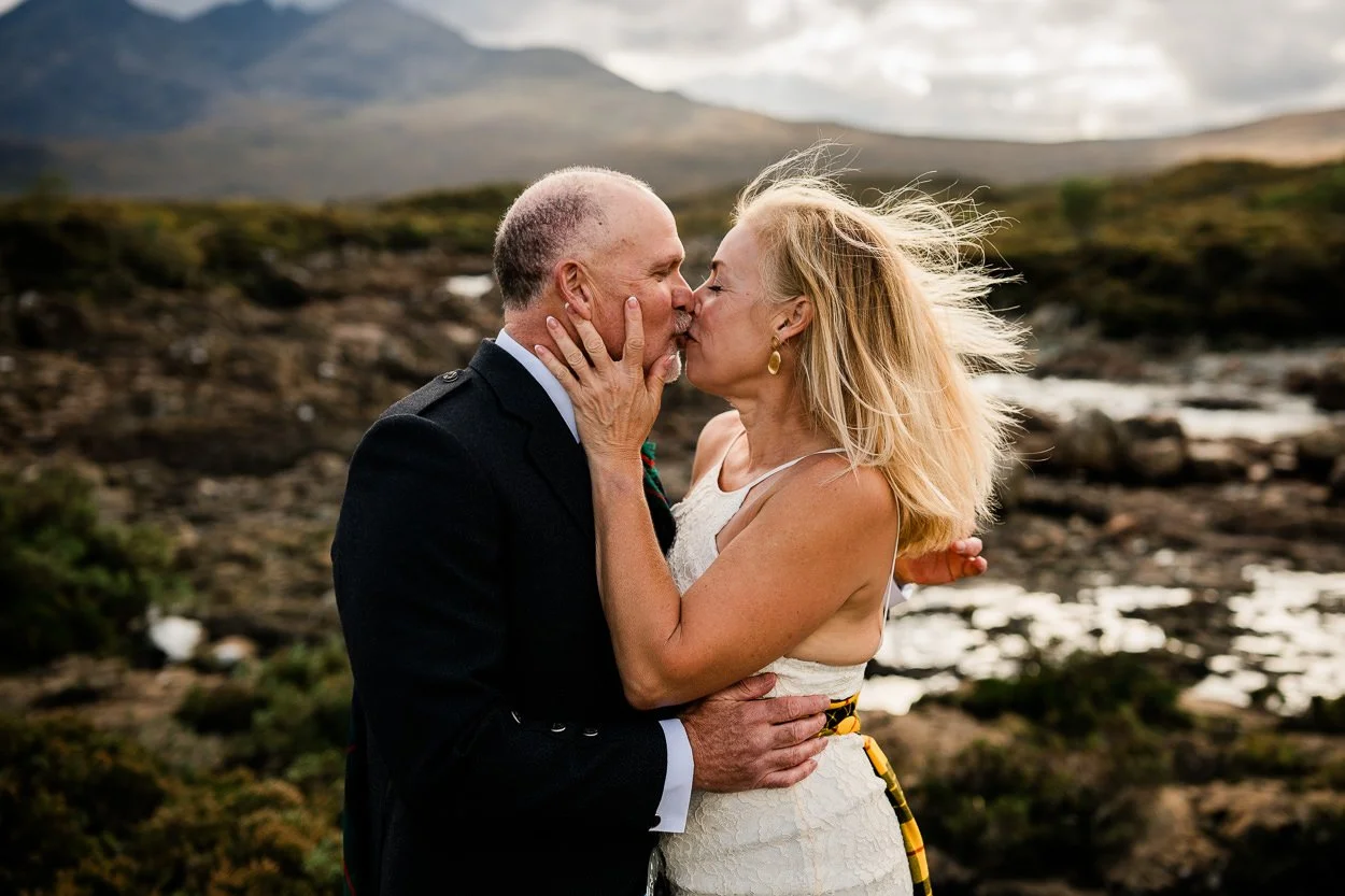 Bride and Groom kissing amongst the Scottish mountains