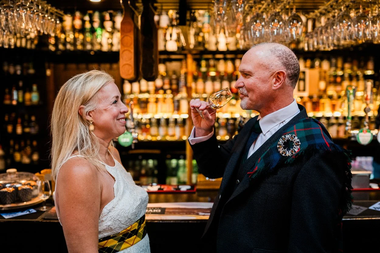 Bride and Groom sharing a whisky in Isle of Skye bar