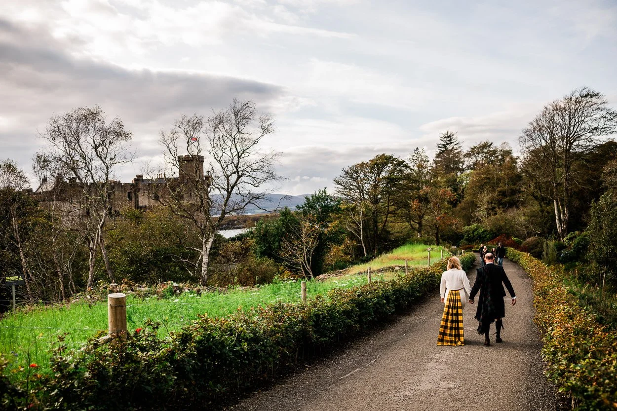 Bride and groom walking towards Dunvegan Castle