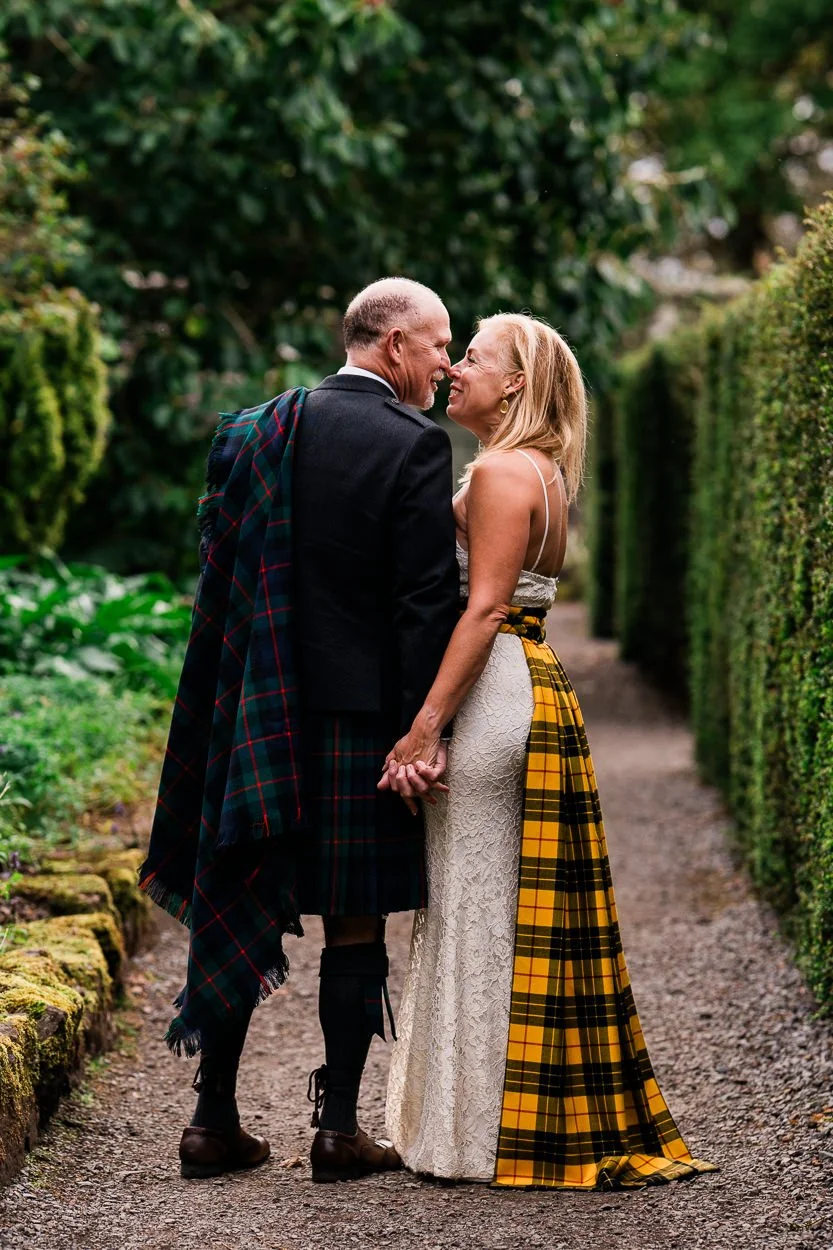 Bride and groom kissing in Dunvegan Castle walled garden