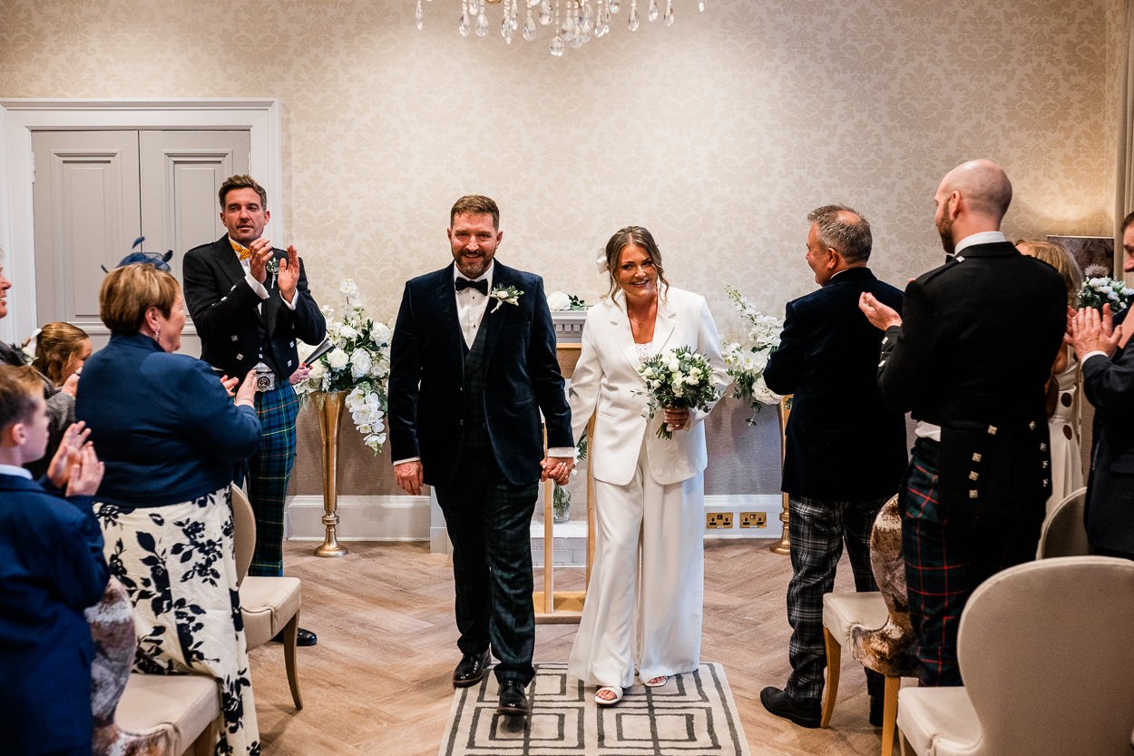 Bride and Groom walk down aisle at Edinburgh city chambers