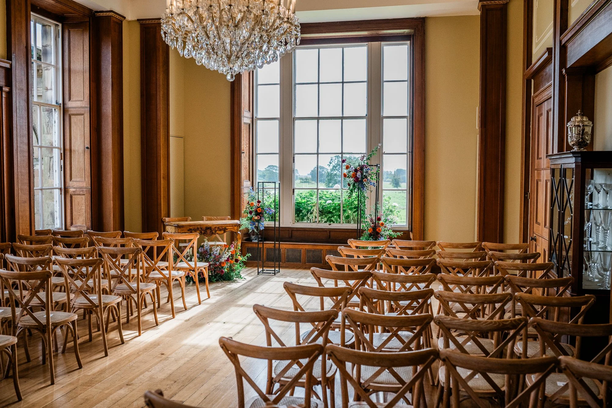Rows of chairs set out for the wedding ceremony in Kinmount House’s light-filled room.