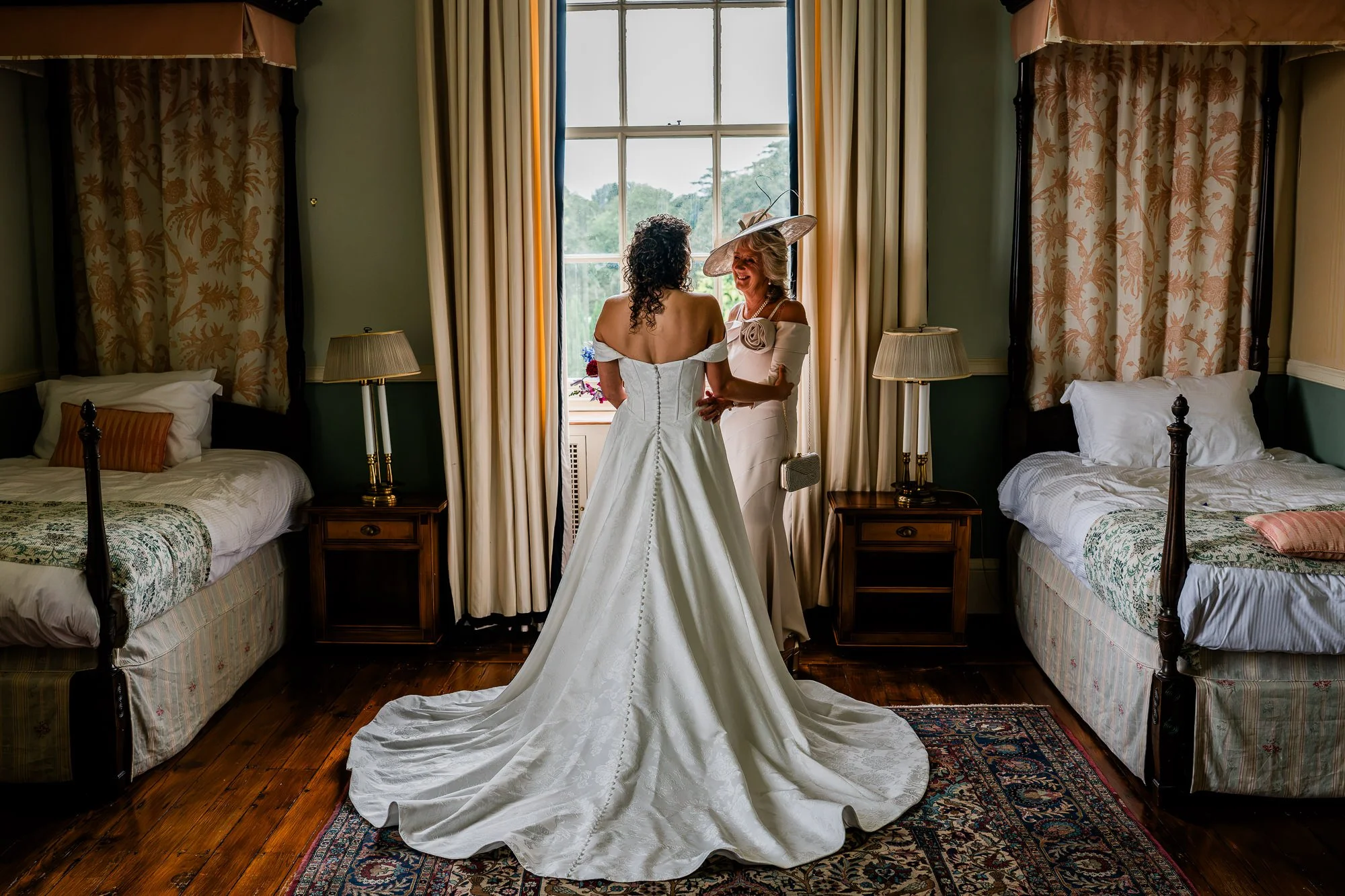 Aimee and a loved one share a moment beside the window while getting ready at Kinmount House.