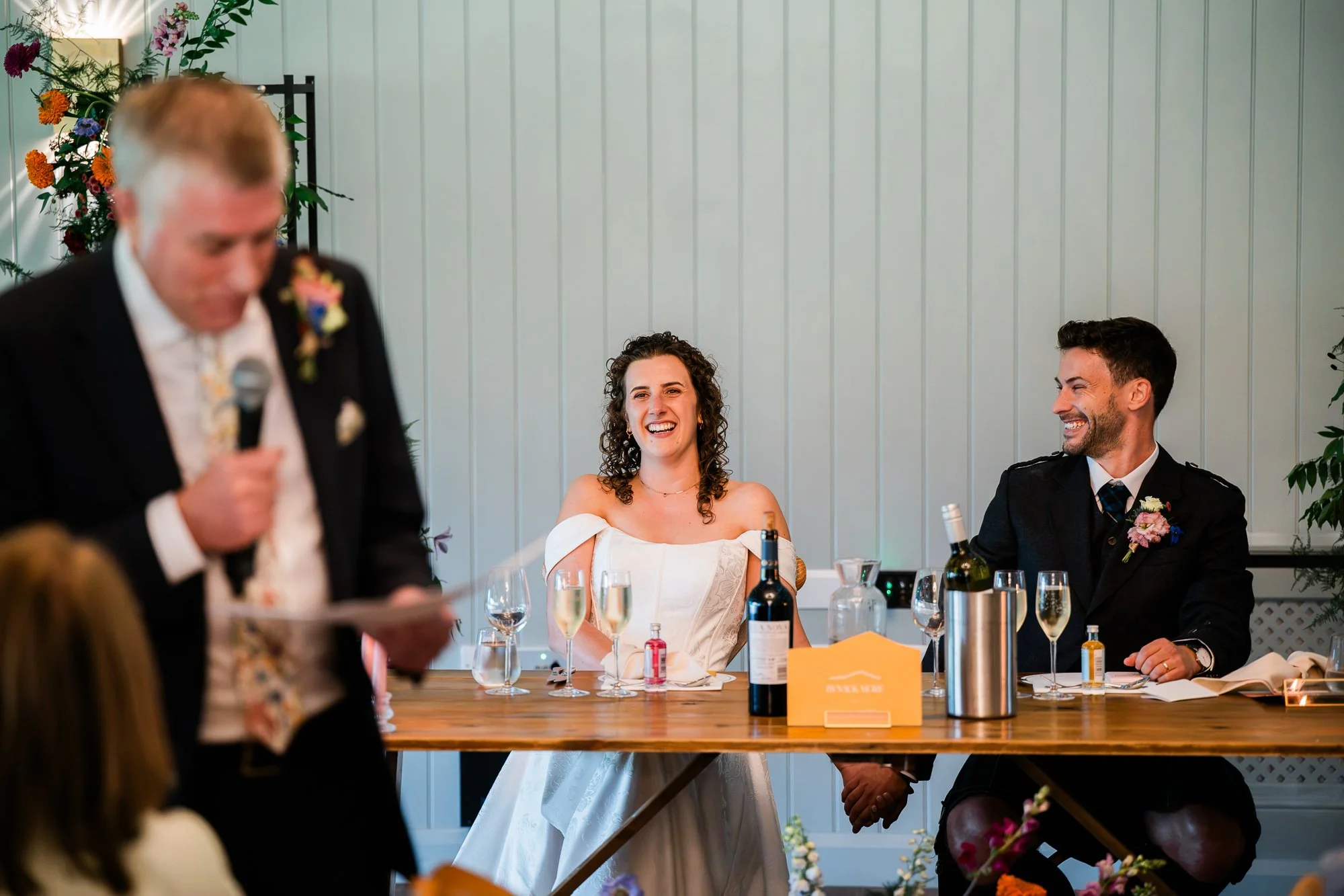 A wedding guest gives a speech beside Aimee and Matthew’s top table.