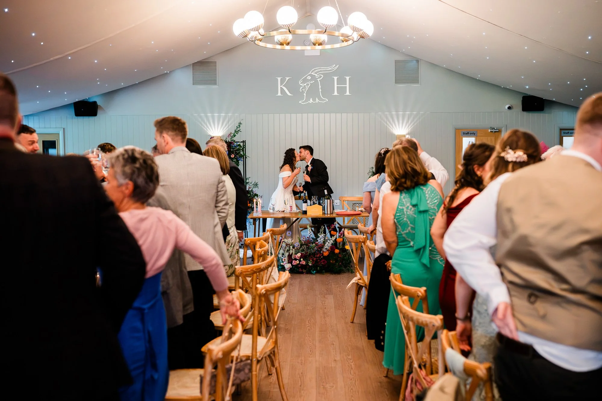 Guests gather and celebrate inside the Kinmount Pavilion during the wedding reception.