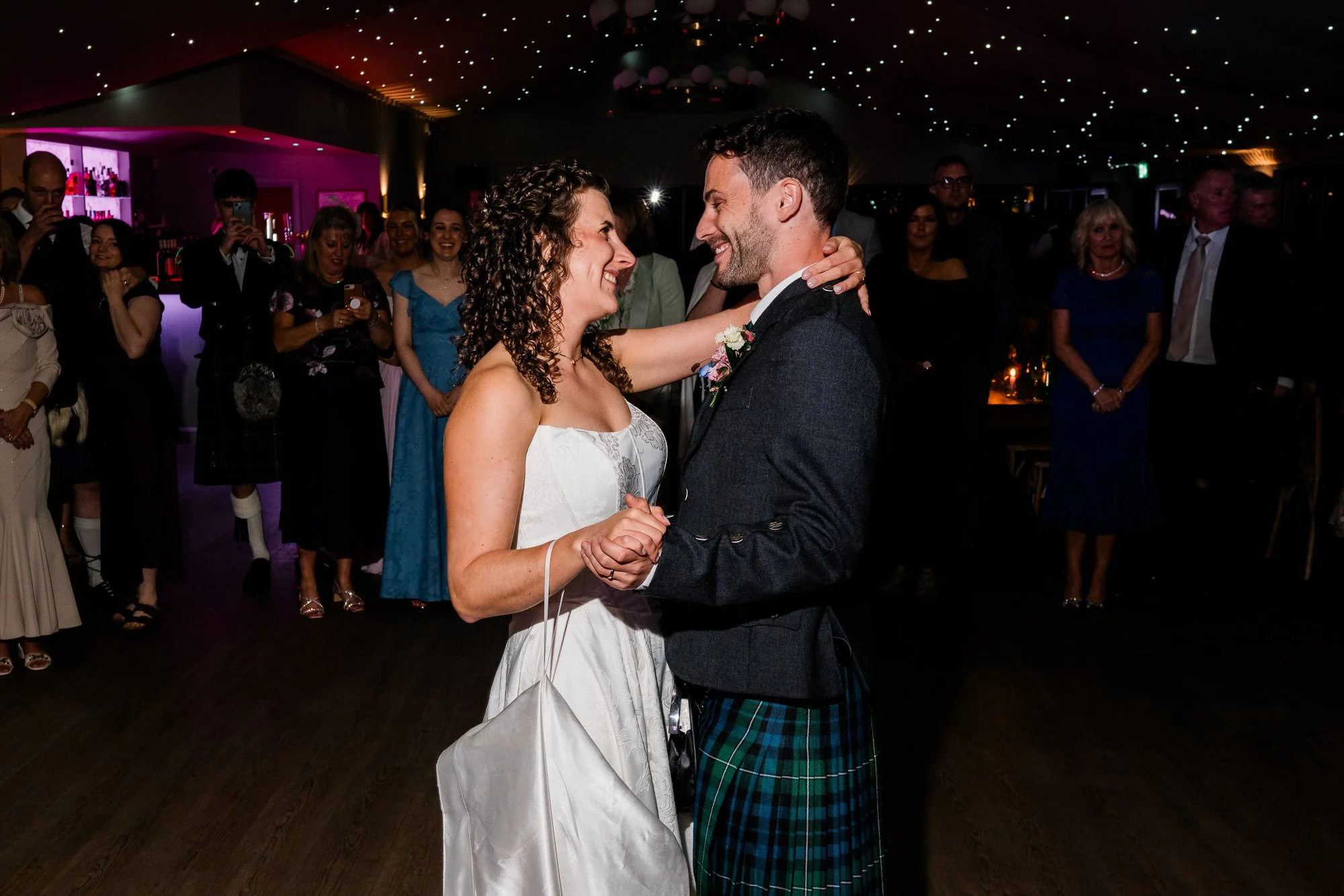 Aimee and Matthew dance together as their guests watch.