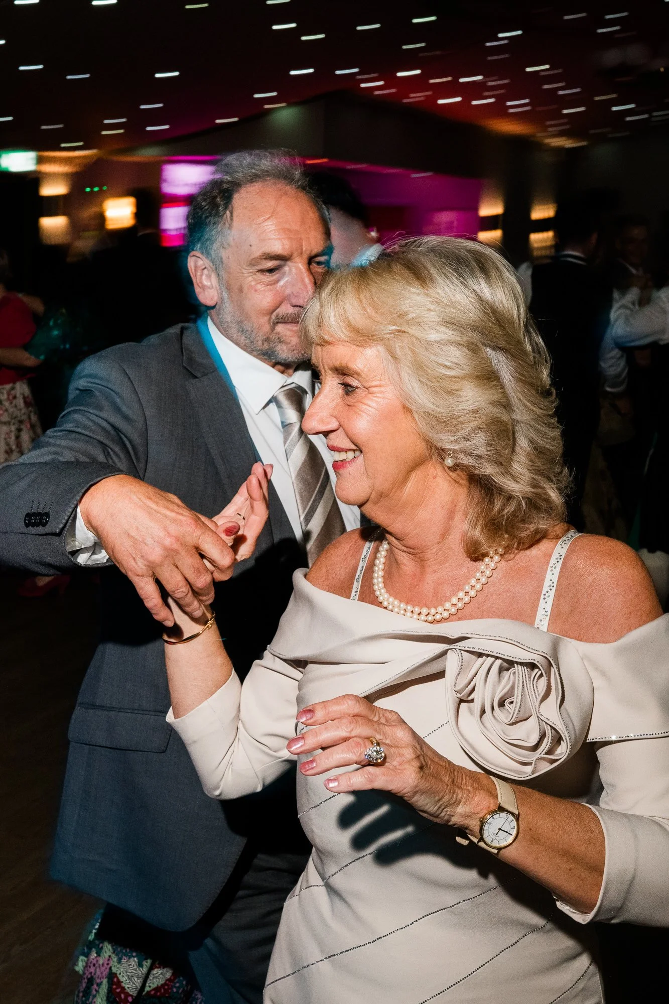 Two wedding guests enjoy the evening dancing together.
