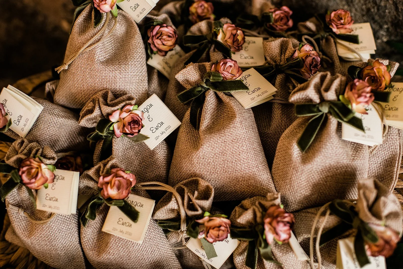 Small wedding favours wrapped in brown paper and tied with ribbon.