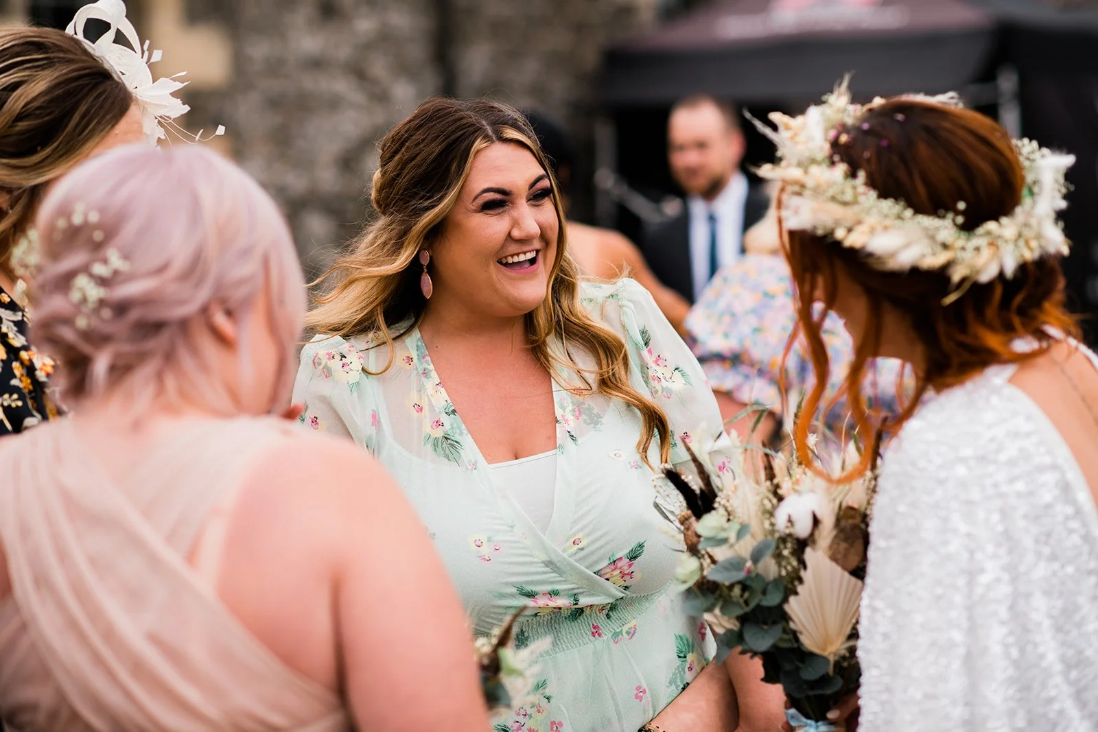 The bride chats with smiling guests in the courtyard after the ceremony.