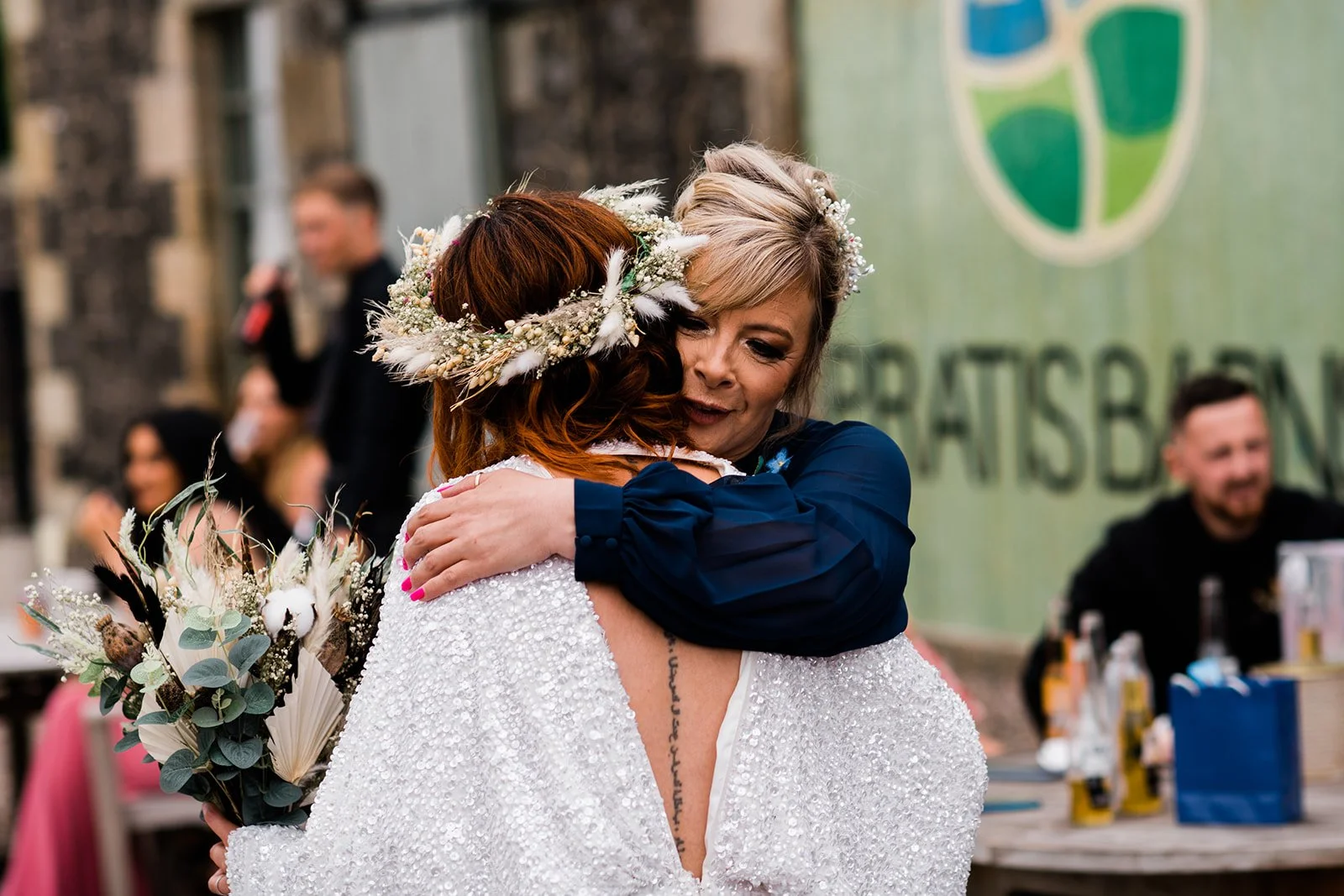 The bride hugs a young child during the wedding reception.
