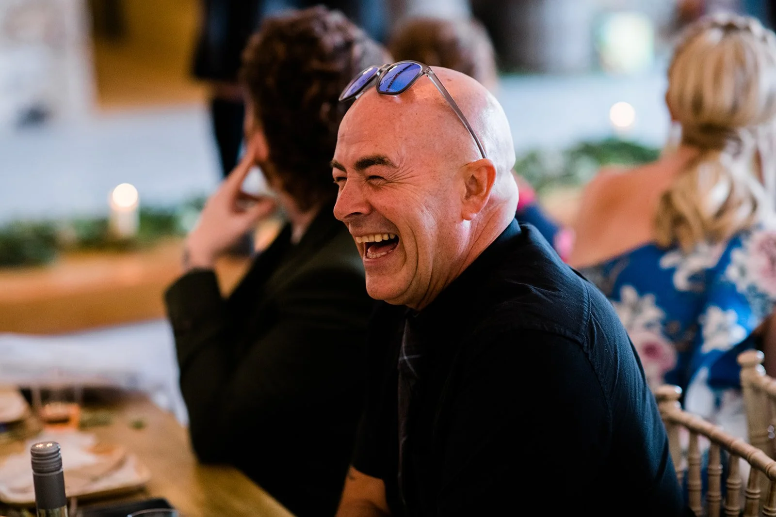 A wedding guest laughs during the reception speeches.