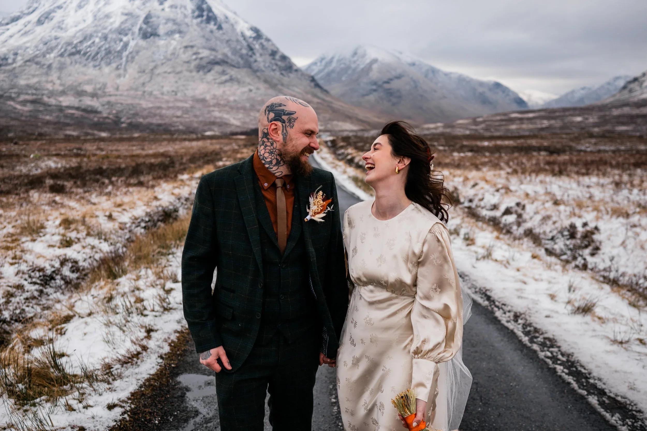 Bride and Groom walking in the snow during Glencoe Elopement