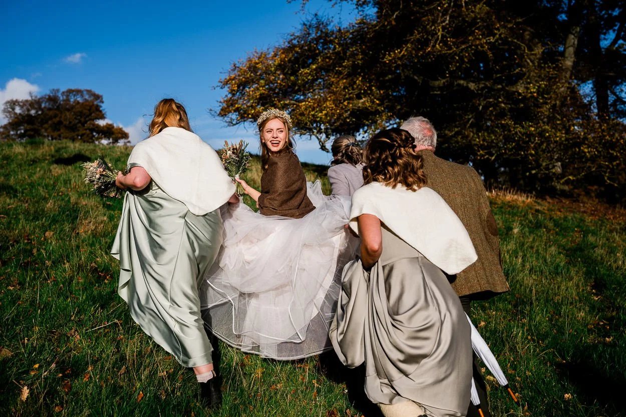 Bridal party walking up a hill to wedding ceremony