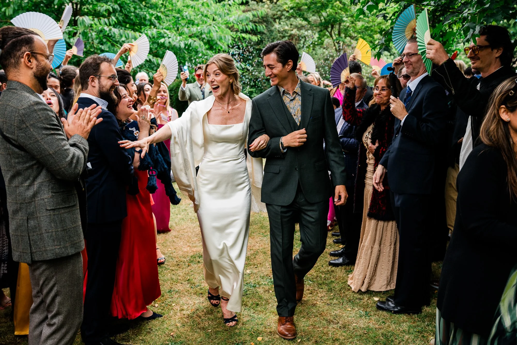 Bride and Groom walking down the aisle in private Edinburgh garden wedding