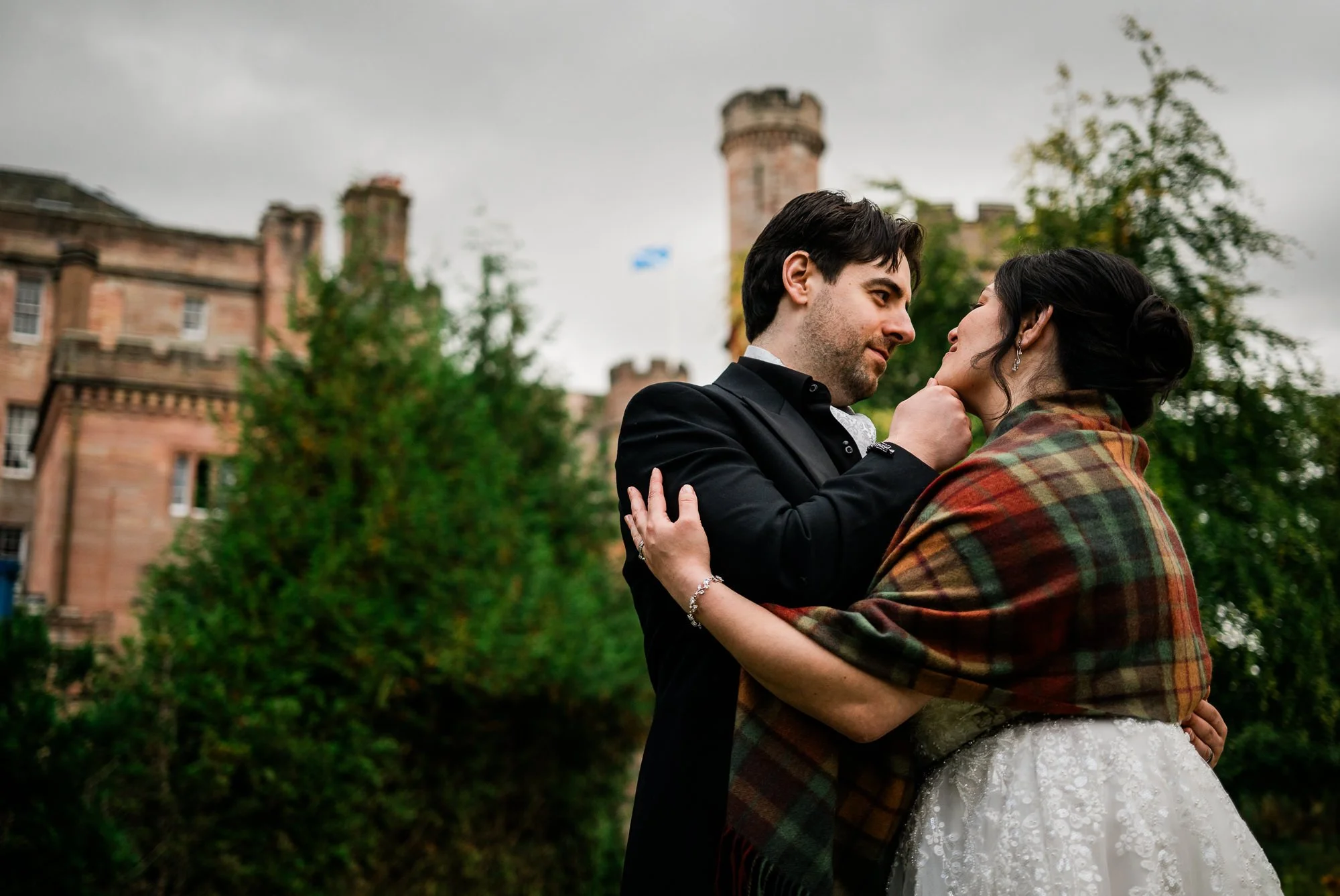 Bride and groom with Dalhousie Castle in background